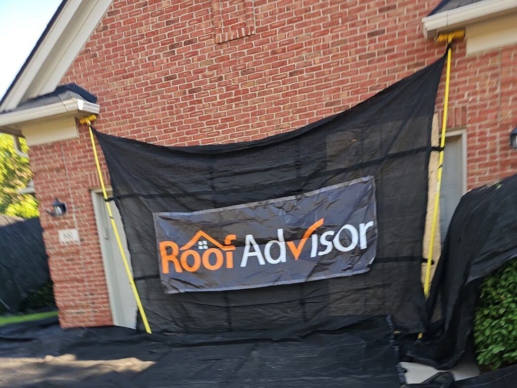 Tarp catchall on the front of garage with the RoofAdvisor Logo