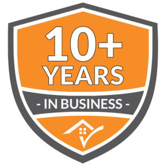 Michigan Roofing Company: 10+ Years in Business Badge. Symbolizes experience and reliability in roofing services. Orange shield design.