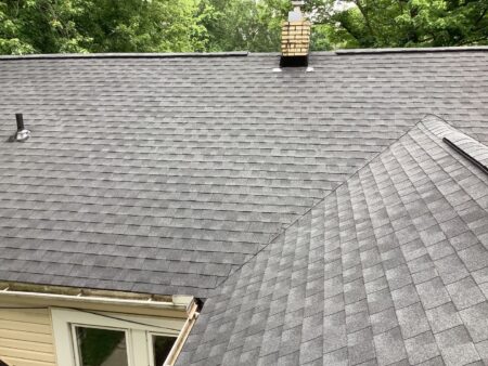 Westland Roof Replacement: Asphalt shingle roof with chimney, gutters, and vents. Image taken on July 13, 2022, showcasing roofing detail.