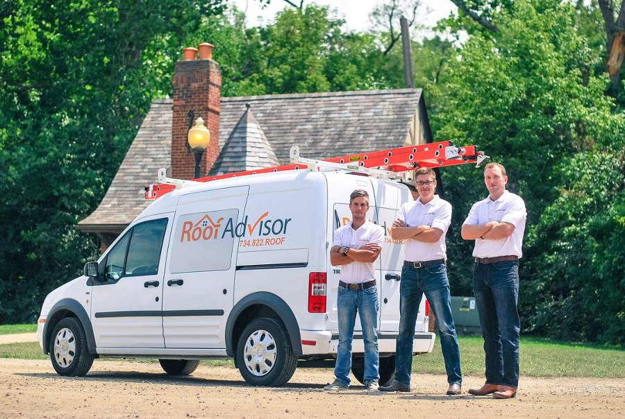 RoofAdvisor team standing infront of a roofing truck