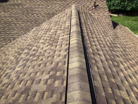 Close-up of a brown asphalt shingle roof on a house.