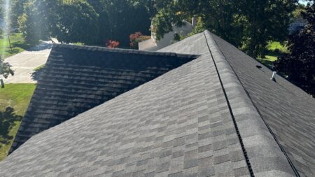 Completed GAF roofing system featuring Cobra SnowCountry ridge ventilation and architectural shingles on Novi home.