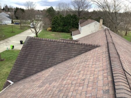 Aging asphalt shingle roof on Novi home showing weathering and wear before roof replacement.