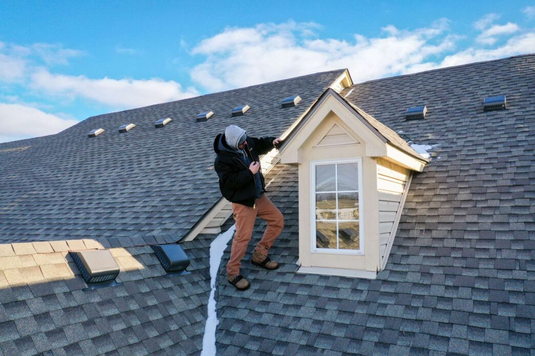 Multi-Family Roofing Inspection. Roofer inspecting roof for leak-free certification. Roof health check ensures no-leak guarantee for 1-year.