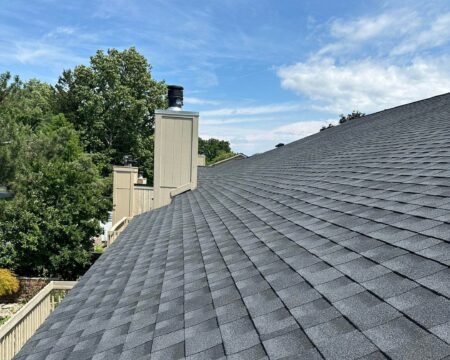 South Hills of Bloomfield roof project update: Close-up of a newly installed gray shingle roof section on a building in Bloomfield, showcasing the roof's texture.