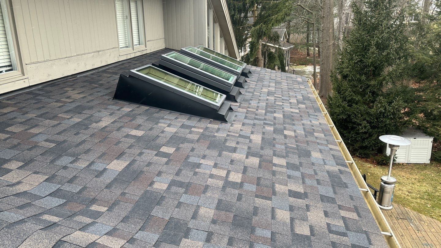 Completed roof replacement on a residential home in Brighton, MI, showing the finished exterior after installation