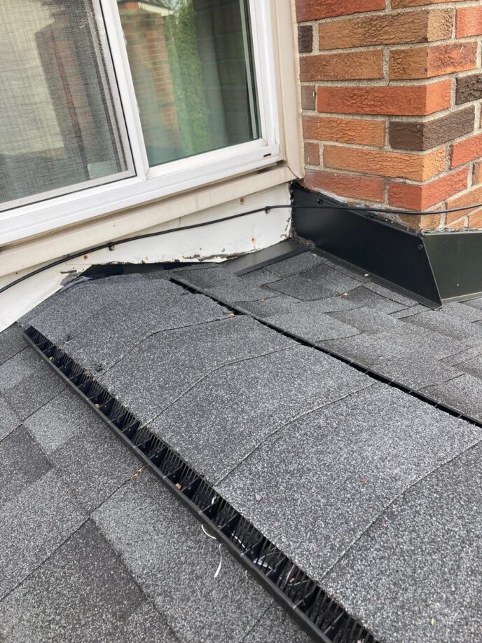 5-Star Roofing: Andrea M. project in Clinton Twp. shows gray shingles, new flashing, and gutter guard installed after roofing work. Quality roofing solutions.