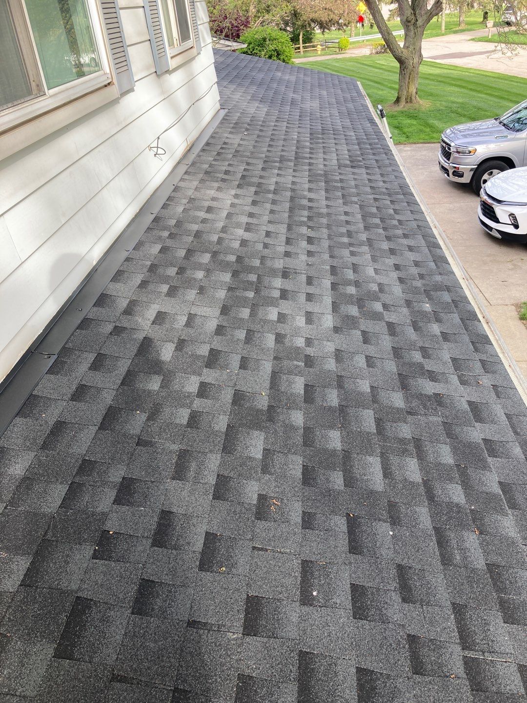 Andrea M's new 5-Star Roof in Clinton Township. The after image showcases the quality of the roofing work by 5-Star Roofing.