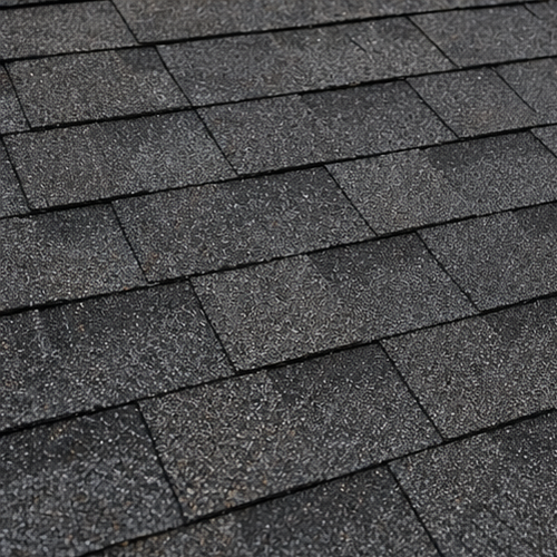 Close-up of asphalt shingles, illustrating multi-family roof lifespan. Asphalt shingles are a common roofing system with varying lifespans. #roofing #shingles