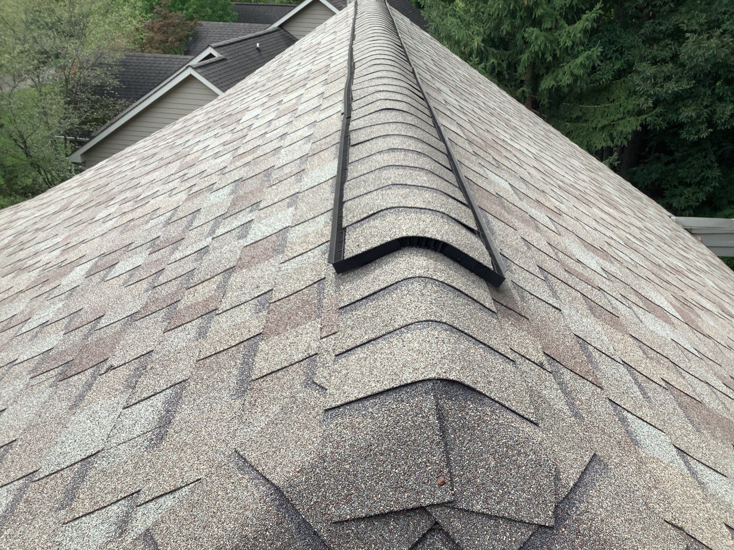 Worn residential roof before replacement in Brighton, MI showing aged shingles in need of repair