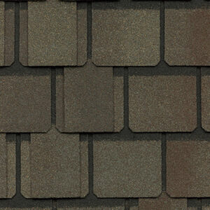 Close-up of Belmont by CertainTeed roofing shingles in Weathered Wood color. Asphalt shingle texture shows varied brown hues. High-quality roofing material.