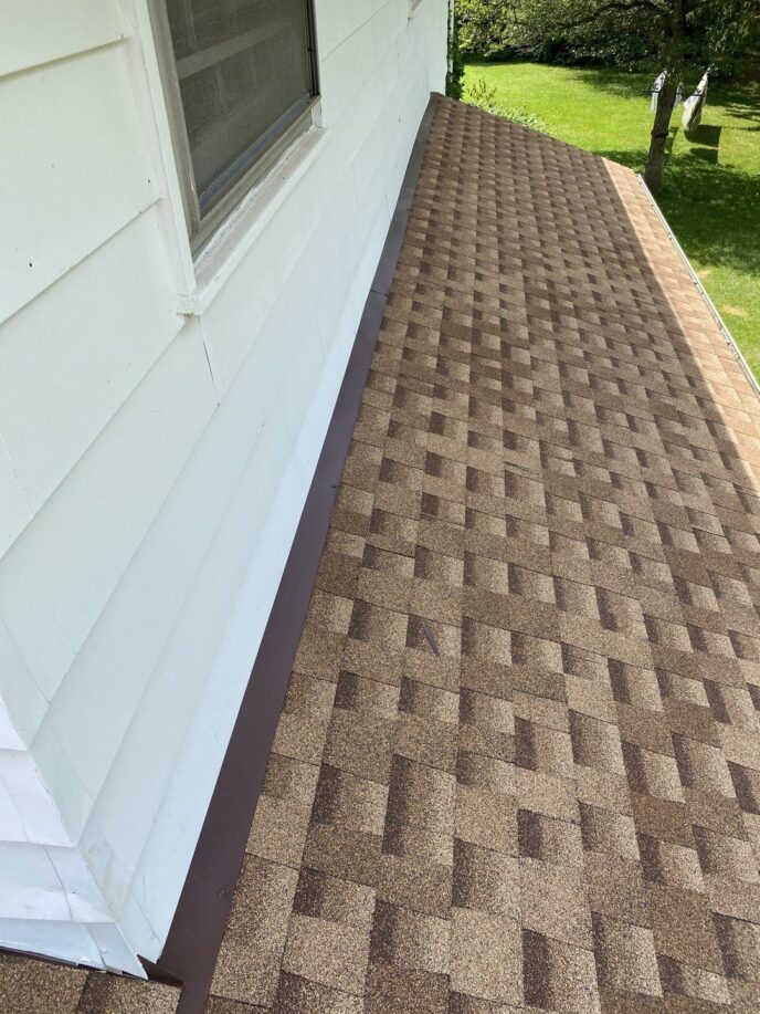 Ann Arbor roof replacement by Bill's! View of the completed roofing project with brown asphalt shingles installed on the house. Excellent roofing.