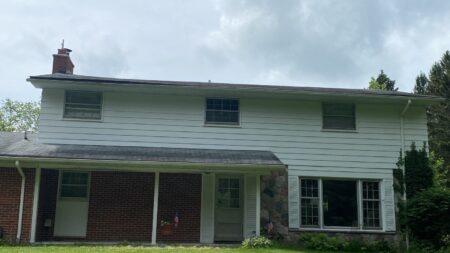 Before Ann Arbor roof replacement on Bill M's home showing the old roof. This image shows the house prior roof work. Bill's Ann Arbor roofing project.