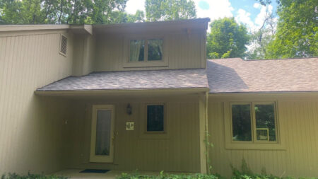 After roof replacement in Canton by Bruce's. Shows a newly installed roof on a home, showcasing the quality of a Canton roof replacement service.