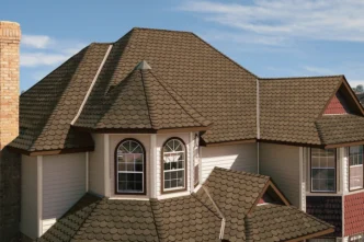 Carriage House Chestnut Shingles on a home. View showcases the roof's texture, color, and architectural style. Durable and beautiful roofing.