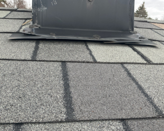 A gap in the flashing around a chimney.