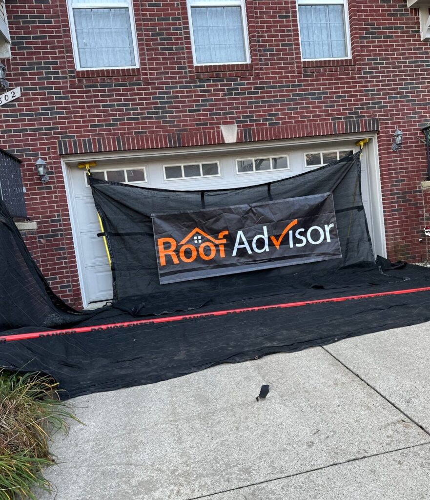 House with RoofAdvisor banner over garage. Roofing services.