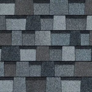 Owens Corning Duration Designer Shingles in Pacific Wave color. Close-up of asphalt roofing material with a textured surface and varied shades of gray and blue.