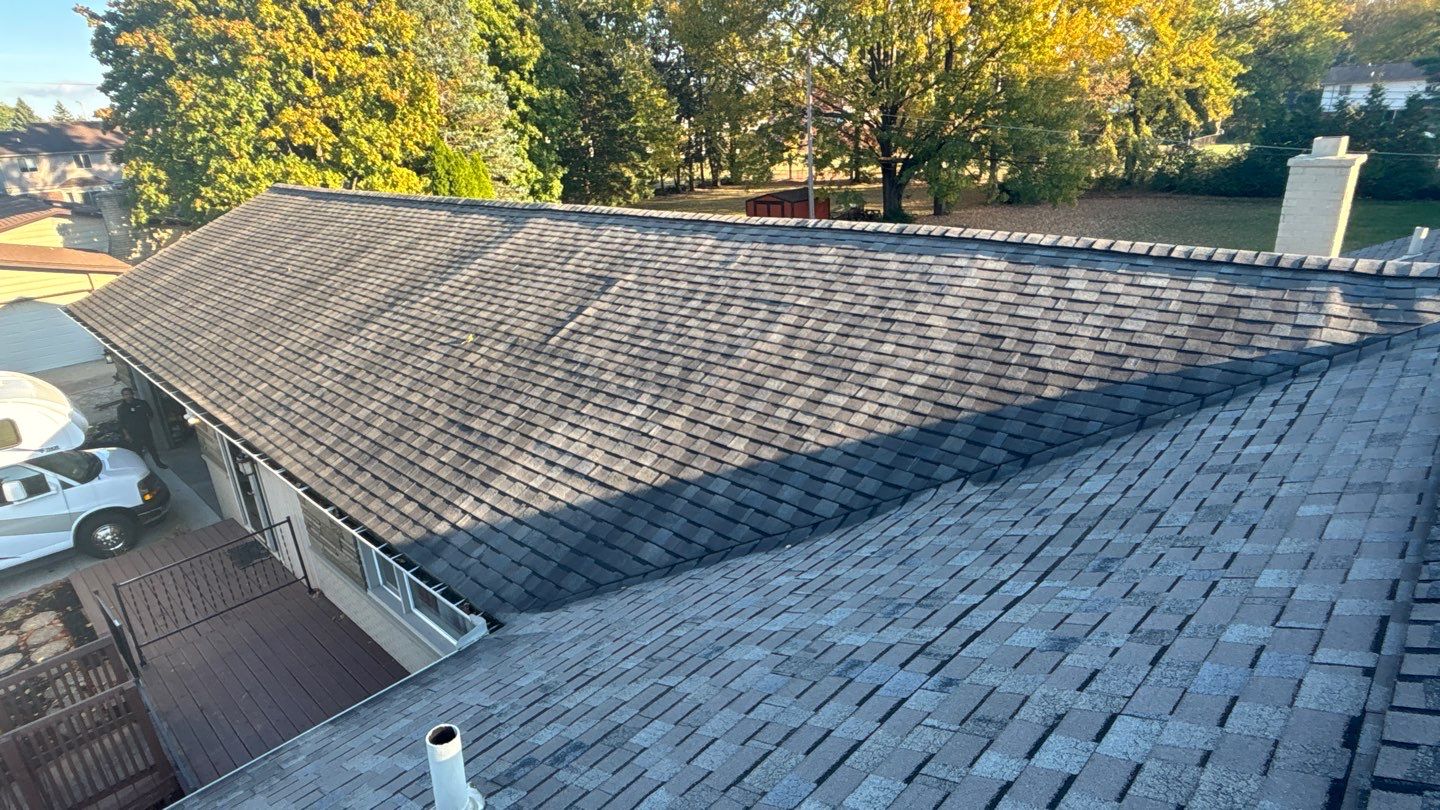 Sloped residential roof with worn asphalt shingles, plumbing vent, and rooftop exhaust vent