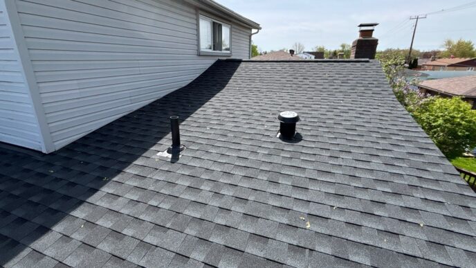 Hip and multiple penetrations on newly installed asphalt shingle roof in Brownstown.