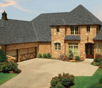 Featured project example: GAF Roofing Camelot II designer shingles in Antique Slate on a brick home.