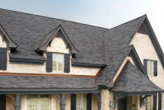 Designer roof system in Castlewood Gray asphalt roofing shingles. GAF Designer Slateline roofing example on a house after existing roof layer tear off. Mimics slate tiles with luxury asphalt shingles.