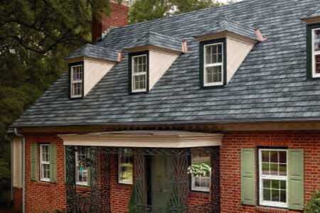 Designer roofing system GAF Slateline roofing example in English Gray on a brick house. The roof has dormer windows and copper accents.