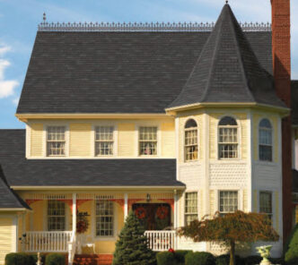 Designer slateline roofing on a yellow home. GAF Designer Slateline example roof in Royal Slate color. Architectural shingles.