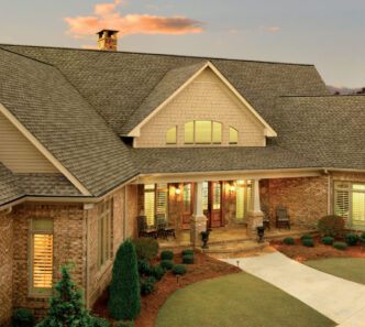 GAF Timberline HDZ in Weathered Wood on a brick home. Example roof showcases the shingle's color and texture, enhancing curb appeal.