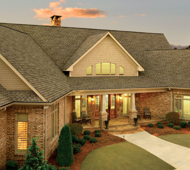 GAF Timberline HDZ in Weathered Wood on a brick home. Example roof showcases the shingle's color and texture, enhancing curb appeal.