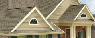 GAF Timberline Natural Shadow Shingles on a home. Example of a roof with natural shadow shingles. Architectural style with brick and siding.