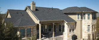 GAF Timberline UHDZ shingles on a home. Charcoal-colored example roof with a chimney. Durable roofing shingles for ultimate protection.