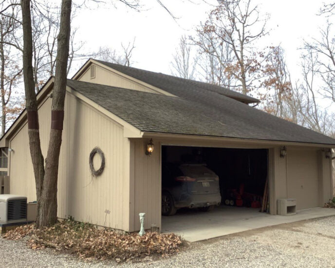Before Canton roof replacement: Garage with old roof needing replacement. View shows the garage, driveway and surrounding trees. Canton roofing project.