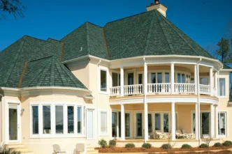 Grand Manor Sherwood Forest shingles on a luxury home. The architectural shingles provide a textured, high-end look for enhanced curb appeal.