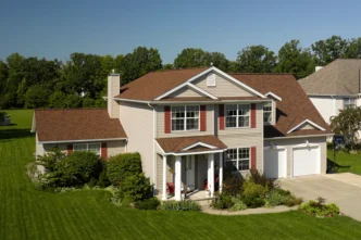 Landmark Pro Max Def Burnt Sienna shingles on a home. Durable roofing with enhanced curb appeal. Ideal for weather protection and beauty.