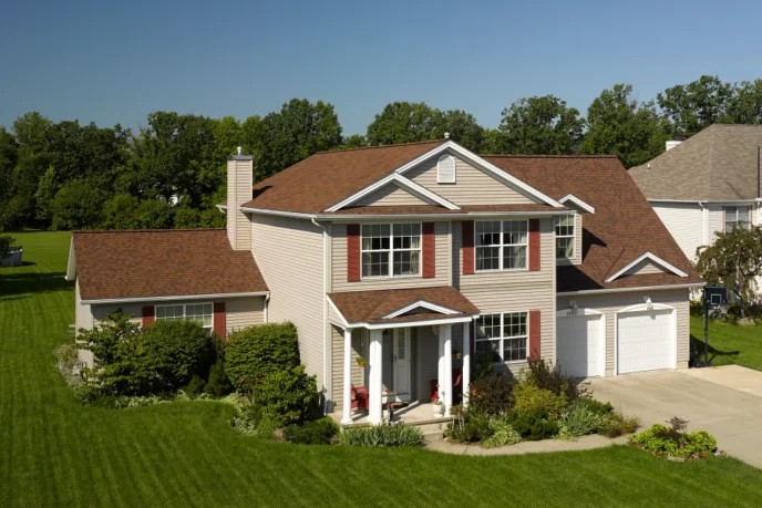 Landmark Pro Max Def Burnt Sienna shingles on a home. Durable roofing with enhanced curb appeal. Ideal for weather protection and beauty.