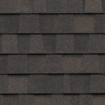 Close-up of CertainTeed Landmark Pro Max Def Espresso shingles. Dark brown roofing material with a textured surface, showcasing the color and design.