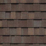 CertainTeed Landmark Pro Max Def Prairiewood shingles. Close-up view of roofing material displaying a rich blend of brown and gray tones, granite texture.