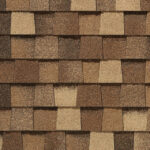 Close-up of CertainTeed Landmark Pro Max Def Resawn Shake shingles. Features varying shades of brown and tan, creating a textured, dimensional roofing visual.