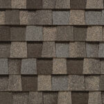 Close-up of CertainTeed Landmark Pro shingles in Max Def Weathered Wood color. Roofing material with a mix of brown, gray, and tan tones. Durable and stylish.