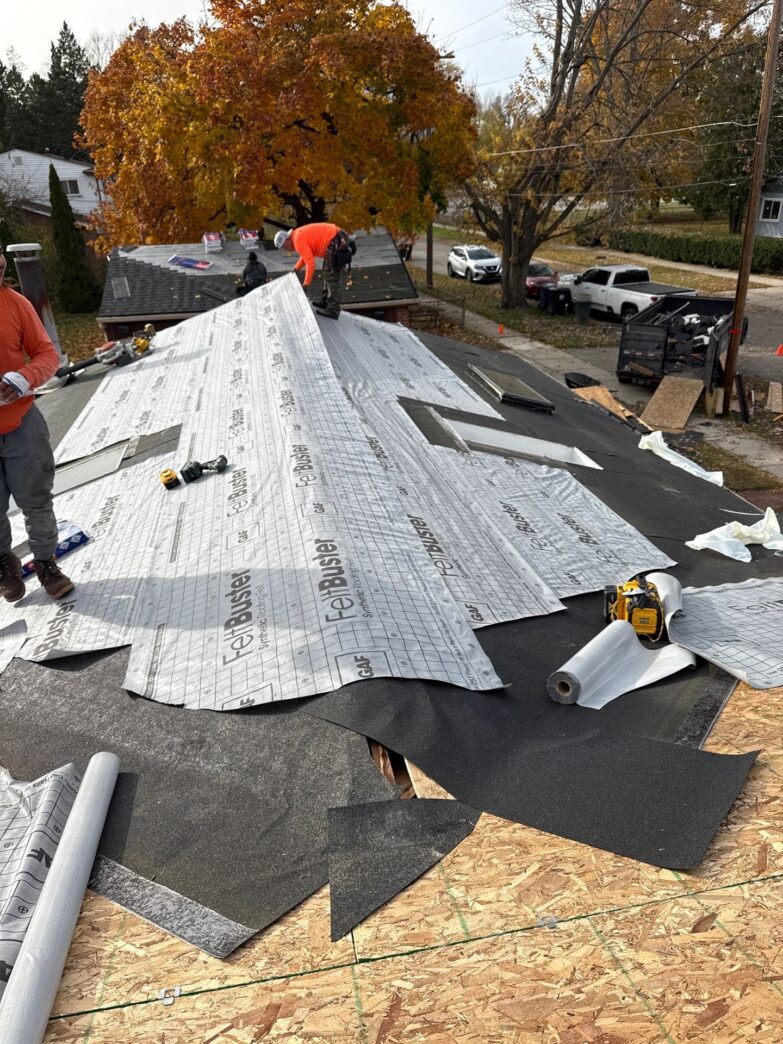 Roof replacement in progress with synthetic underlayment installation in Michigan