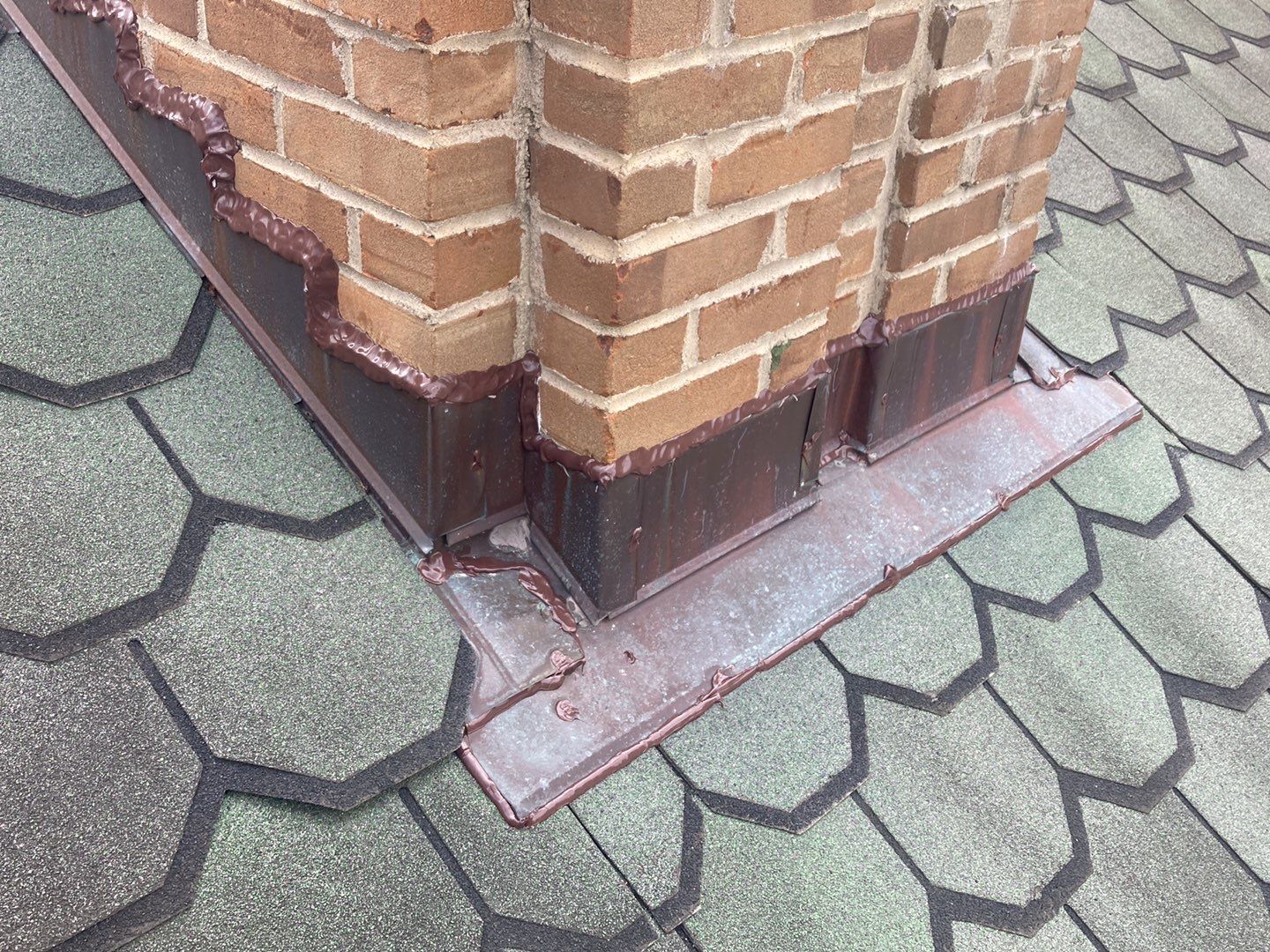 The flashing on the chimney of Lori's Plymouth home after roof repair.