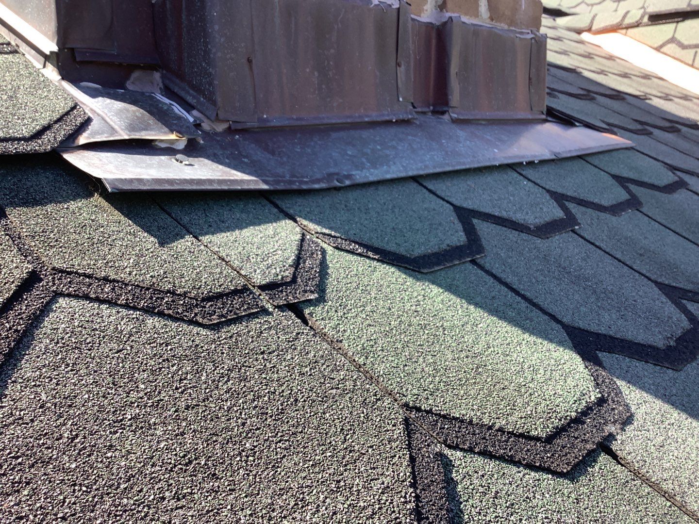 The counter flashing on the chimney of Lori's Plymouth home before roof repair.