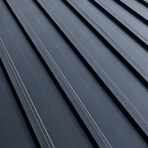 Close-up of a metal tile roof, illustrating the lifespan of metal roofing systems for multi-family homes. Guide to roofing lifespan and materials.