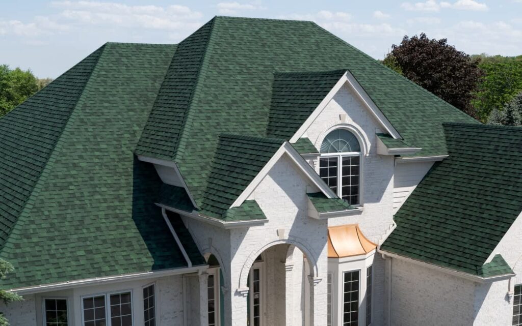 Owens Corning Duration Chateau Green shingles on a home. Durable, attractive roofing solution. High-quality Owens Corning roofing for lasting protection.
