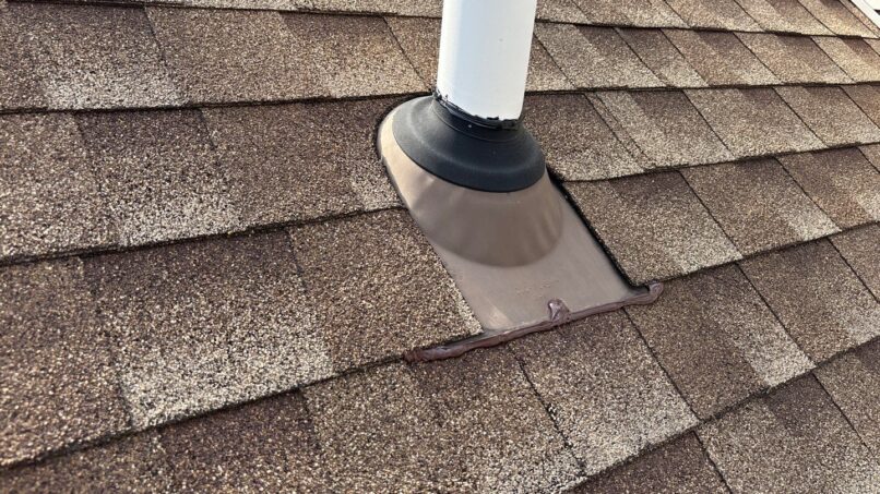 Paul M 5-Star Roofing: Repaired roof flashing around a vent pipe in Plymouth. Shows detail of roofing shingles and waterproof seal after repair.