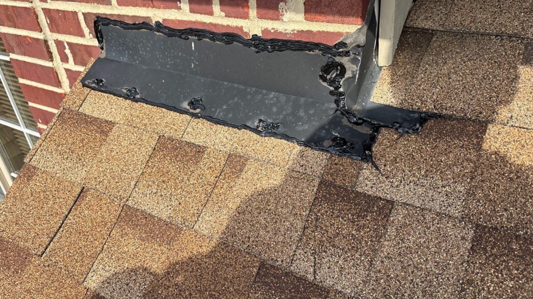 Paul M 5-Star Roofing repair in Plymouth: Close-up of roofing shingles with freshly sealed flashing around chimney base, ensuring a watertight roof seal.