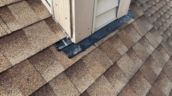 Paul M.'s 5-Star Roofing repair in Plymouth: Close-up of repaired roof flashing around a siding corner, showcasing expert roofing repair work and attention to detail.