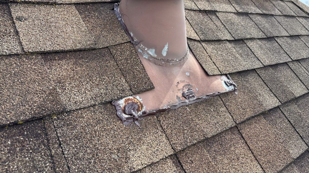 Paul M 5-Star Roofing repair in Plymouth: Close-up of a roof vent pipe flashing professionally sealed after roof repair. Leak prevention by experts.
