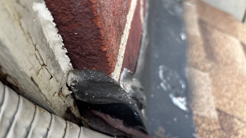 Close-up of damaged roof flashing before 5-Star Roofing repair in Plymouth. Shows deterioration needing Paul M's expertise for a 5-star roofing solution.